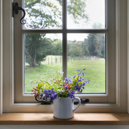 flowers in a vase on a windowsill